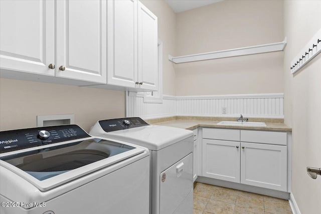 laundry area with sink, cabinets, and independent washer and dryer