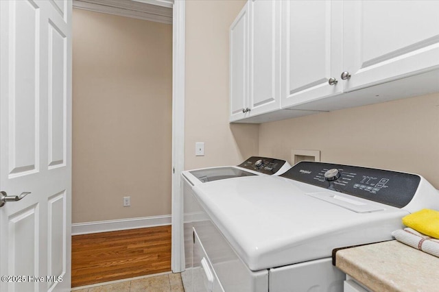 laundry area featuring cabinets and washer and clothes dryer