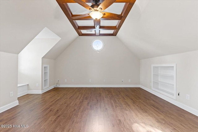 bonus room featuring lofted ceiling with beams, dark wood-type flooring, ceiling fan, and built in shelves