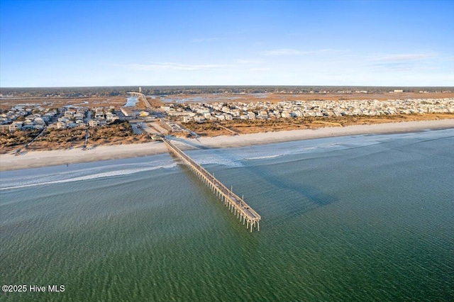 drone / aerial view with a water view and a beach view