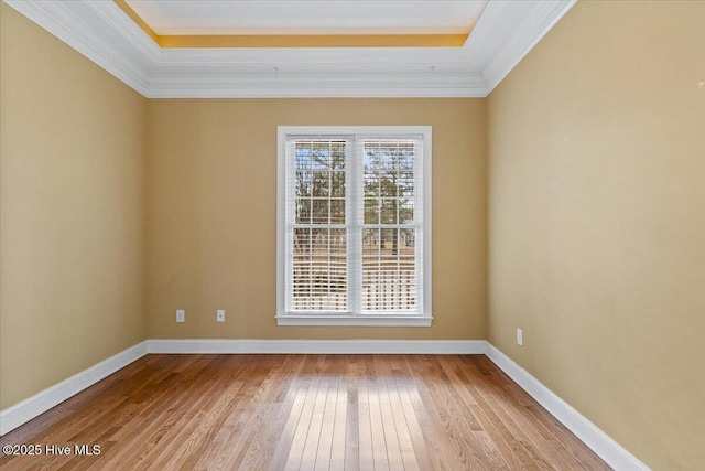 empty room with ornamental molding and light hardwood / wood-style flooring