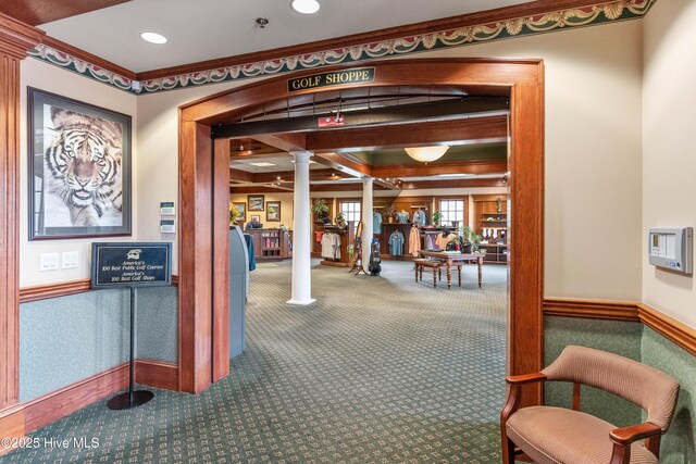 hallway featuring washer / clothes dryer, ornamental molding, and light colored carpet