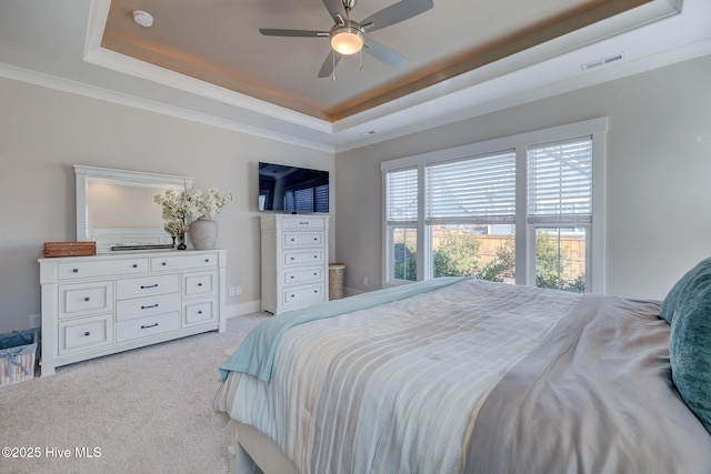 bedroom featuring a tray ceiling, ceiling fan, and light colored carpet