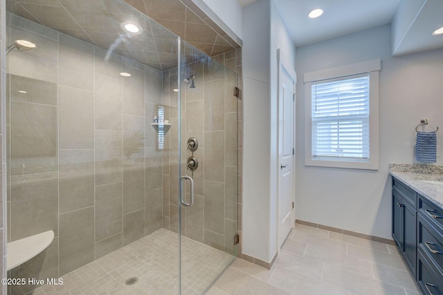 bathroom featuring vanity, tile patterned floors, and walk in shower