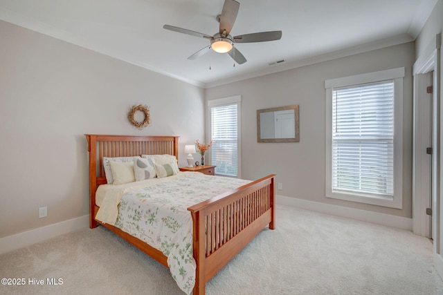 bedroom featuring multiple windows, light carpet, ceiling fan, and ornamental molding