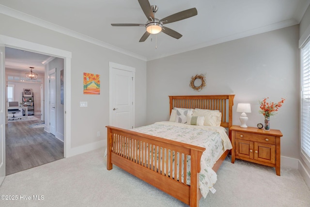 bedroom featuring ceiling fan, light colored carpet, and crown molding