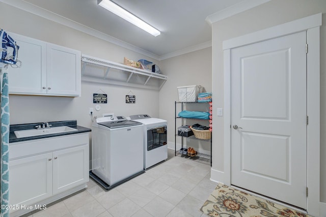 clothes washing area with separate washer and dryer, crown molding, sink, and cabinets