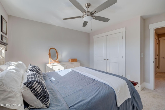 carpeted bedroom featuring a closet and ceiling fan