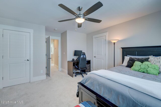 bedroom featuring light colored carpet and ceiling fan