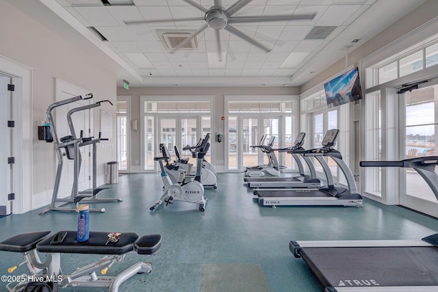 exercise room with french doors, a paneled ceiling, and ceiling fan