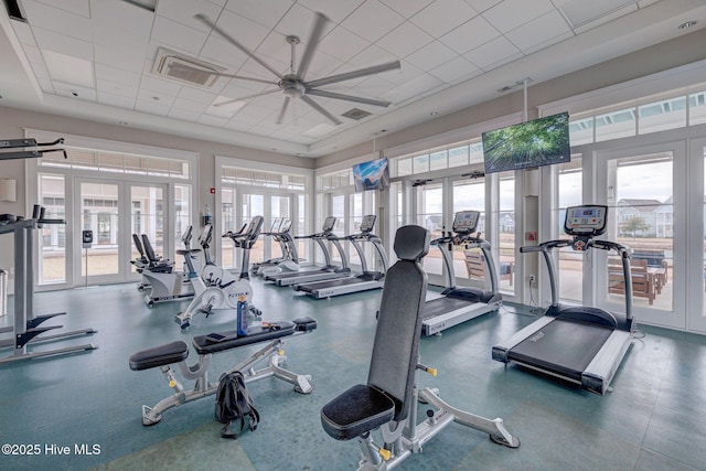 exercise room featuring a healthy amount of sunlight, french doors, and a drop ceiling