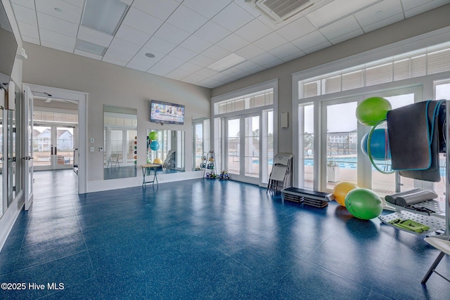 exercise room featuring french doors and a drop ceiling