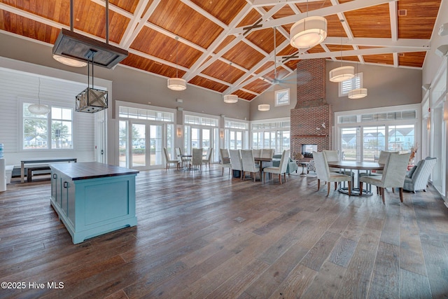 kitchen featuring decorative light fixtures, high vaulted ceiling, and wooden ceiling