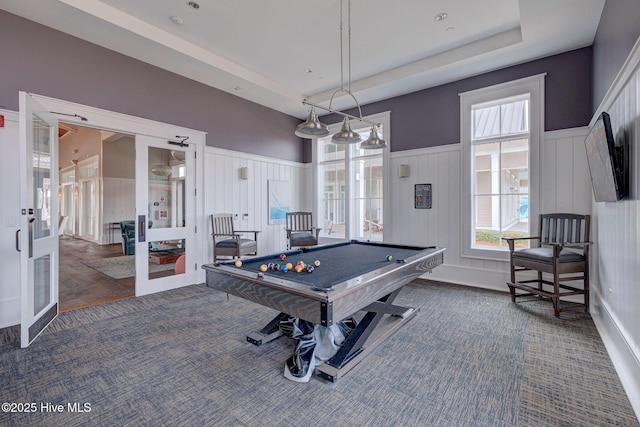 game room with a healthy amount of sunlight, a raised ceiling, pool table, and french doors