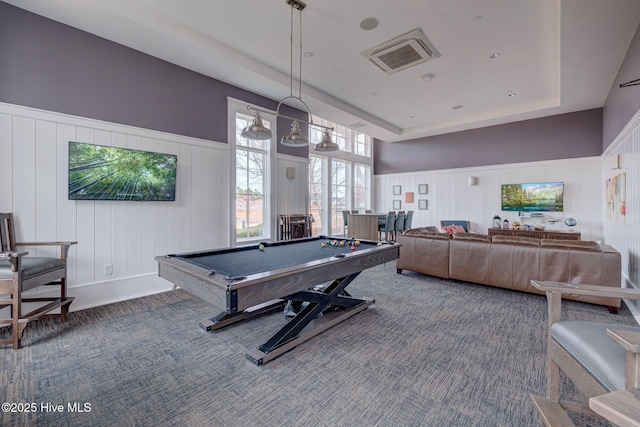 game room with a tray ceiling, wooden walls, and pool table