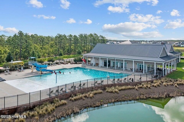 view of swimming pool featuring a patio area and a water slide