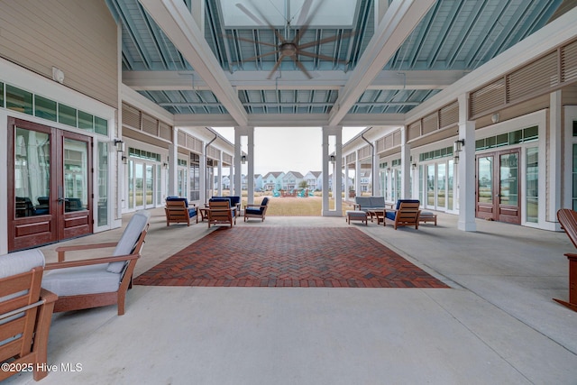 interior space with ceiling fan and french doors