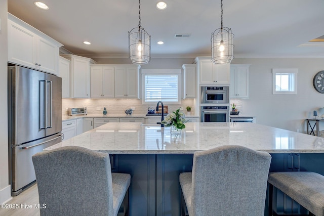 kitchen featuring a spacious island, white cabinetry, and stainless steel appliances