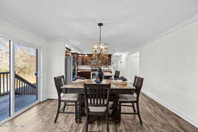 dining area featuring hardwood / wood-style floors, a chandelier, and ornamental molding