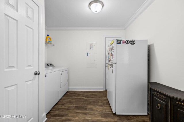 clothes washing area with washer and clothes dryer, ornamental molding, dark wood-type flooring, and electric panel