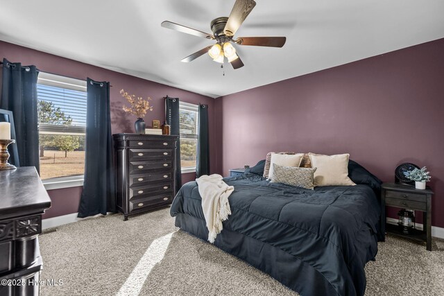 bedroom with light carpet and ceiling fan