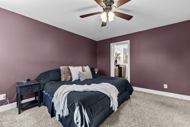 bedroom with ceiling fan, light colored carpet, and connected bathroom