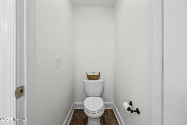 bathroom with hardwood / wood-style flooring and toilet