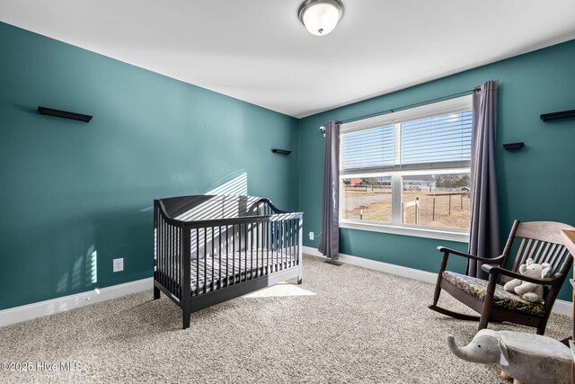 bedroom with carpet flooring and a nursery area