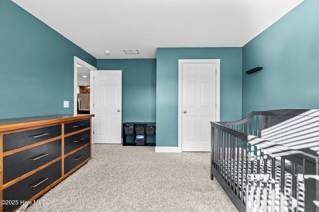 carpeted bedroom with stainless steel fridge