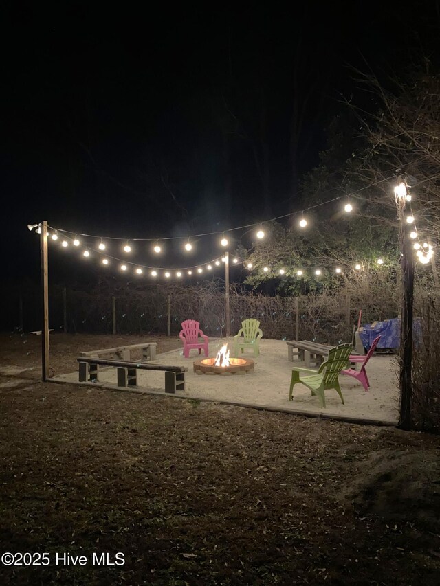 yard at night with an outdoor fire pit