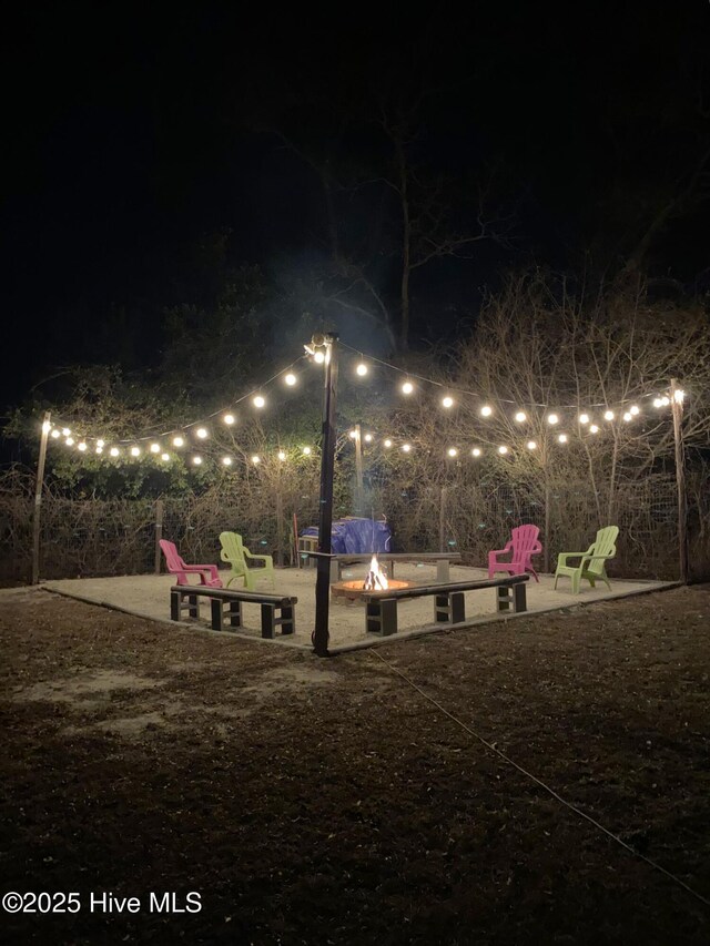 view of community with a fire pit and a patio