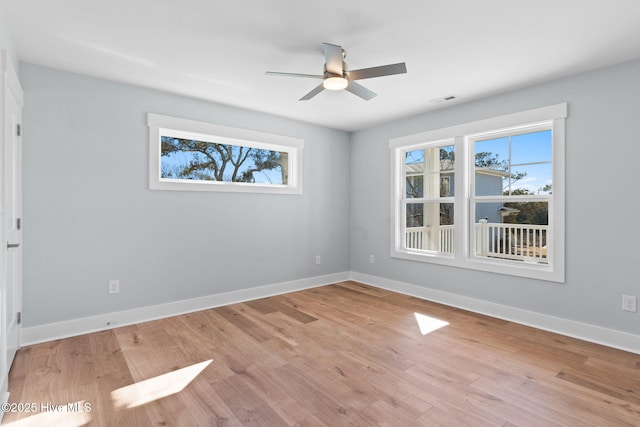 118 SE 9th St, Oak Island, NC 28465 - unfurnished room featuring visible vents, light wood-style flooring, ceiling fan, and a healthy amount of sunlight