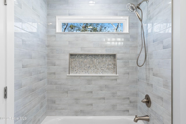 full bathroom with bathing tub / shower combination and a healthy amount of sunlight