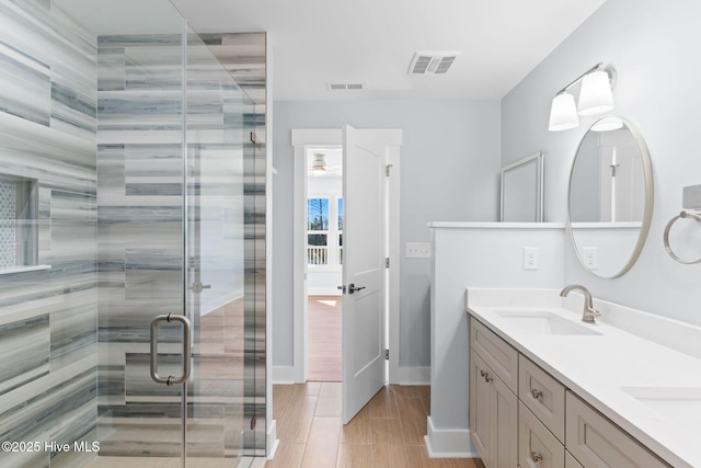 118 SE 9th St, Oak Island, NC 28465 - bathroom featuring double vanity, a sauna / steam room, a stall shower, and wood tiled floors