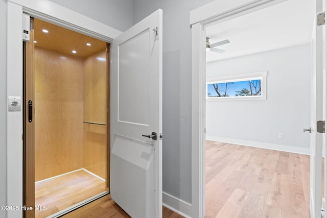 bathroom with baseboards, elevator, recessed lighting, wood finished floors, and a ceiling fan