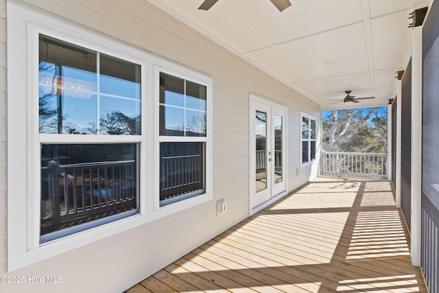 wooden terrace with french doors and a ceiling fan