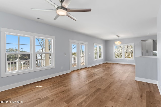 unfurnished living room featuring light wood-type flooring, visible vents, baseboards, and ceiling fan