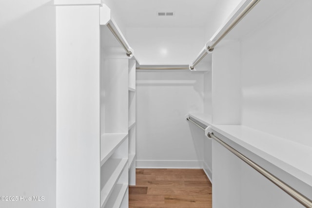 spacious closet with visible vents and light wood-type flooring