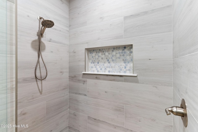 full bath with a tile shower