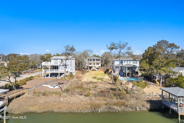 rear view of property with a water view