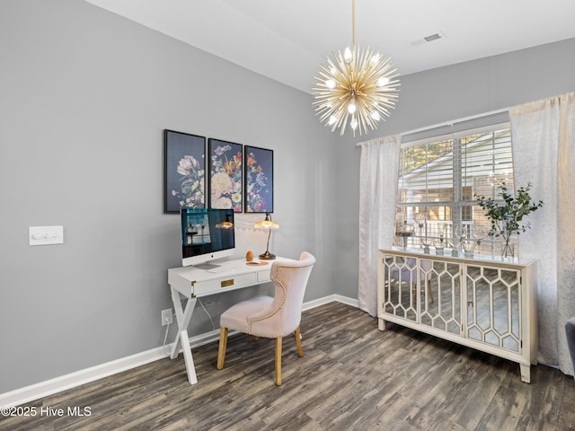 home office with dark hardwood / wood-style flooring and an inviting chandelier