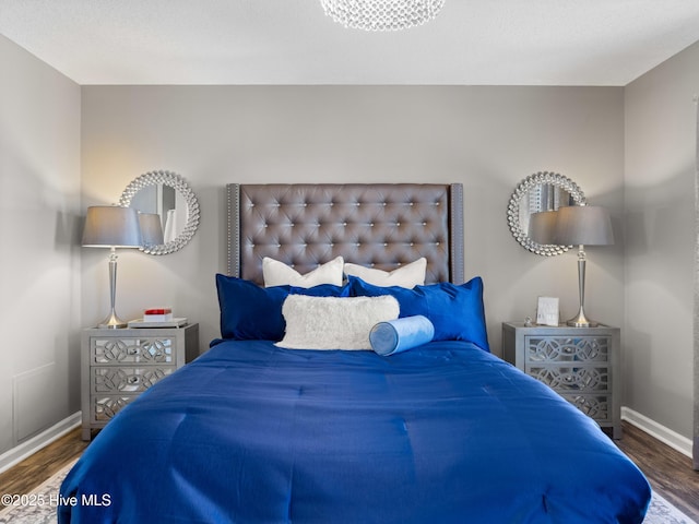 bedroom with dark hardwood / wood-style flooring and a textured ceiling