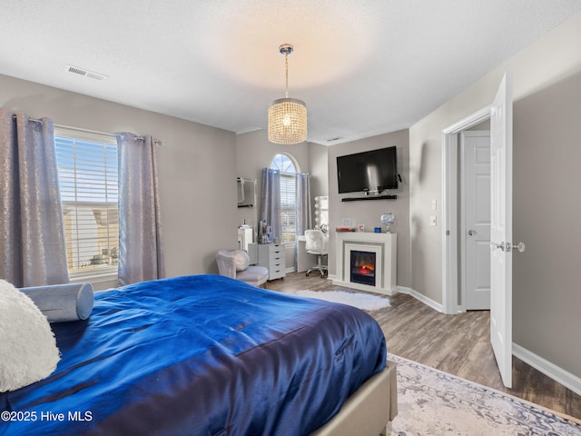 bedroom featuring a textured ceiling and hardwood / wood-style flooring