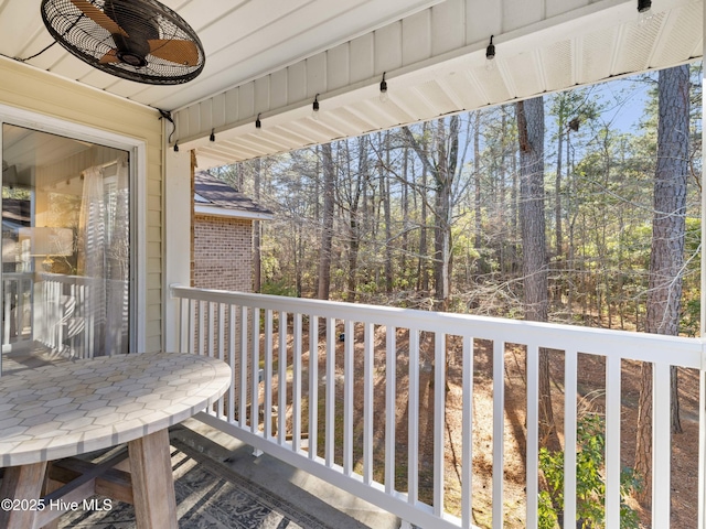 wooden balcony with a wooden deck and ceiling fan