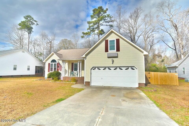 view of front of property featuring a garage, a porch, and a front lawn