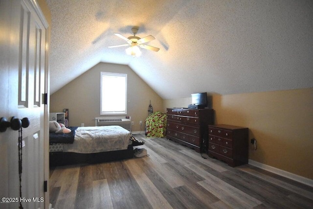 bedroom featuring hardwood / wood-style flooring, vaulted ceiling, a textured ceiling, and ceiling fan