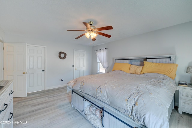 bedroom with ceiling fan and light wood-type flooring