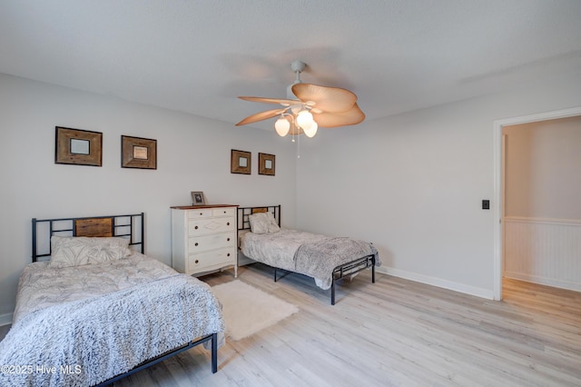 bedroom with light hardwood / wood-style flooring and ceiling fan