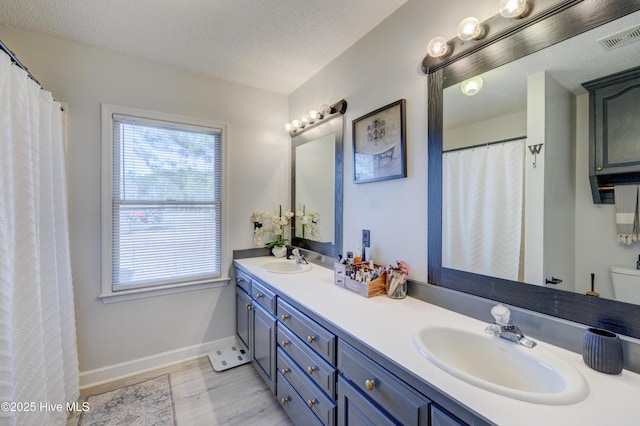 bathroom with vanity and a textured ceiling