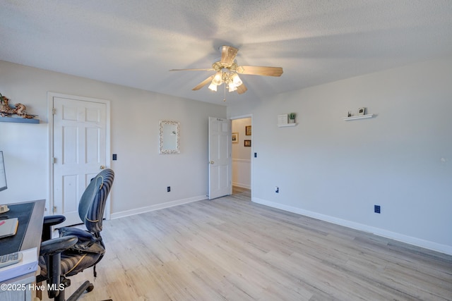 home office with ceiling fan, a textured ceiling, and light hardwood / wood-style flooring